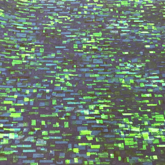 Patterned fabric with green and blue rectangular shapes on a dark background