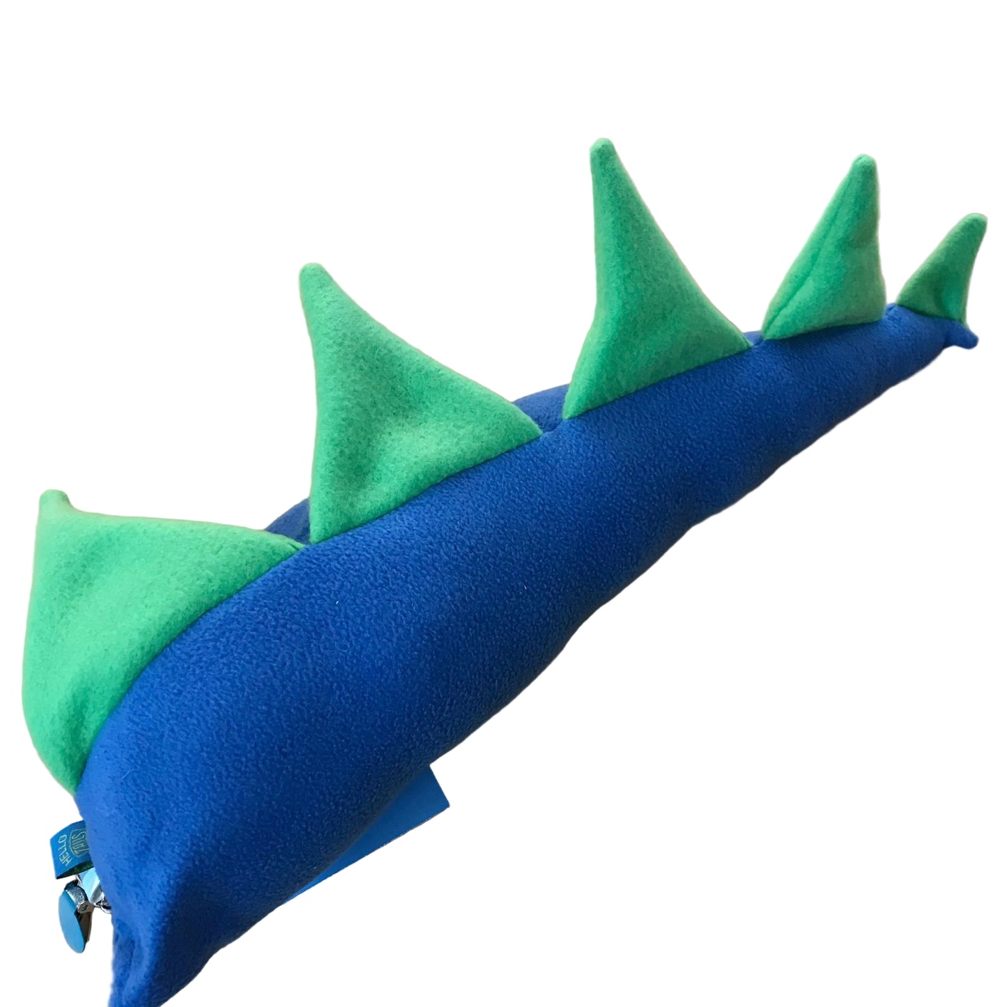 A blue and green dinosaur tail with pointed green spikes, photographed on a light wood surface.