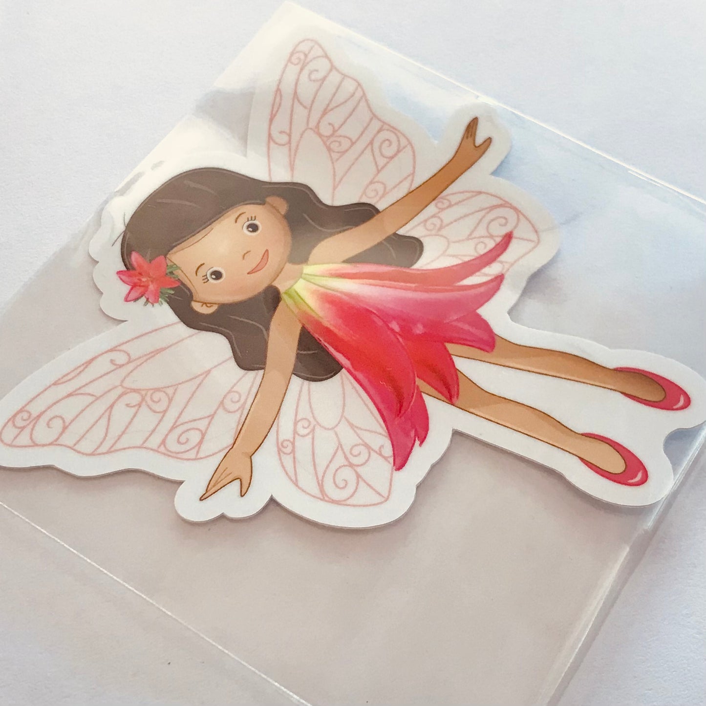 Sticker of a fairy with pink dress and wings on a white background