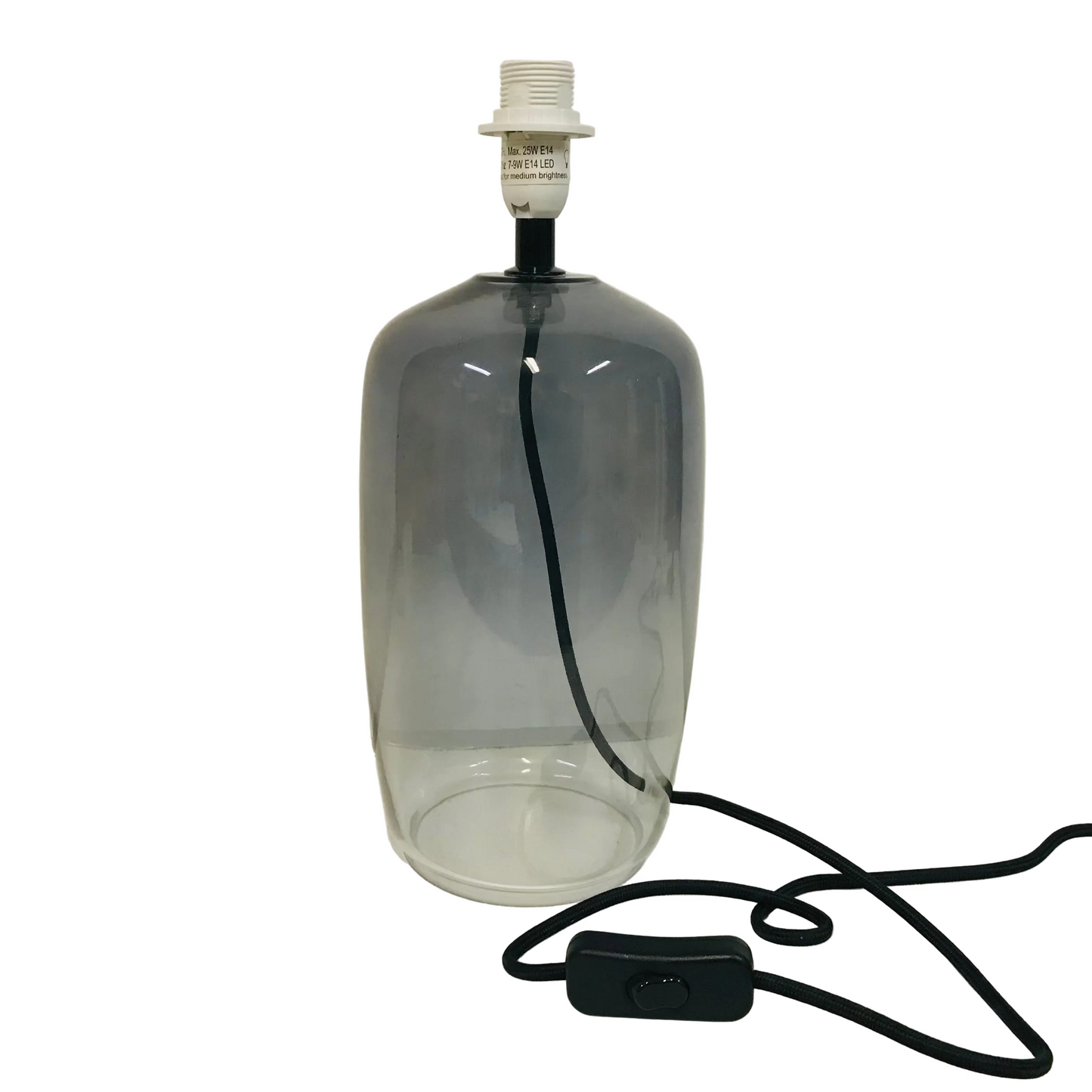 Clear glass bottle repurposed as a lamp with black cord on a white background