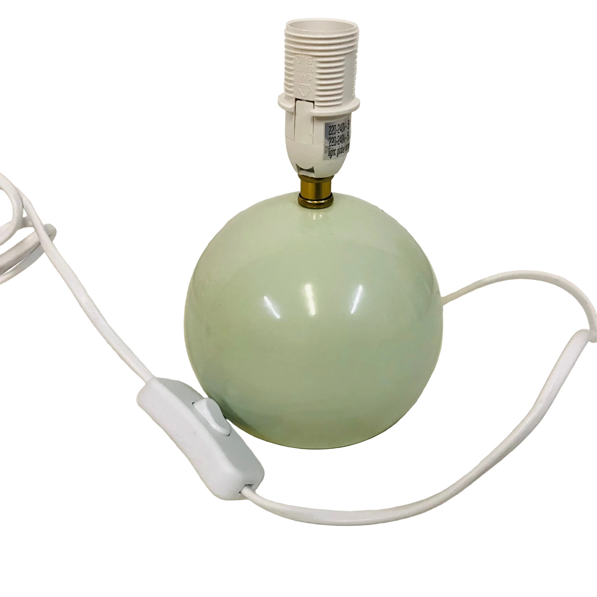 Green ceramic lamp base with white cord on a light background