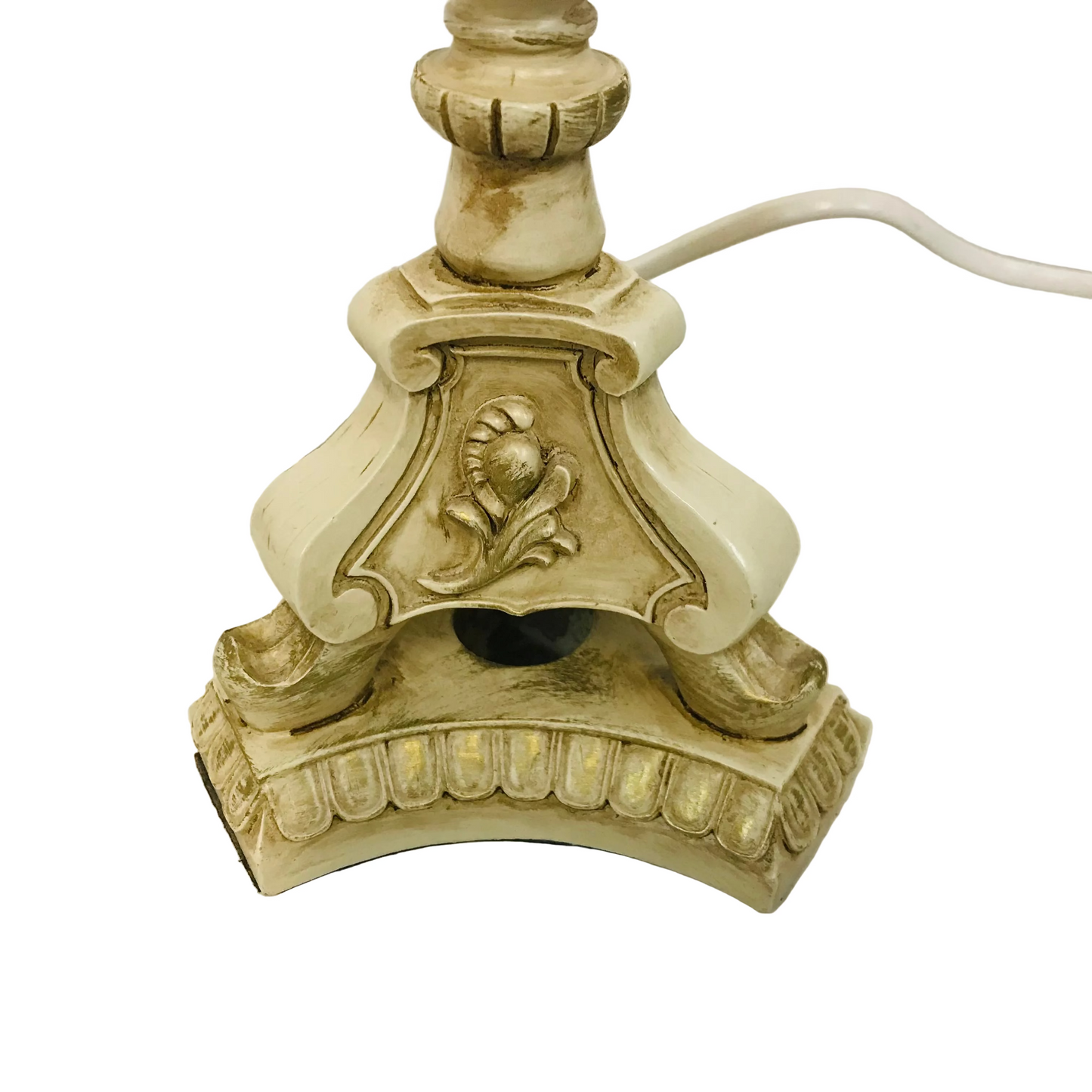 Decorative lamp base with intricate design on a white surface