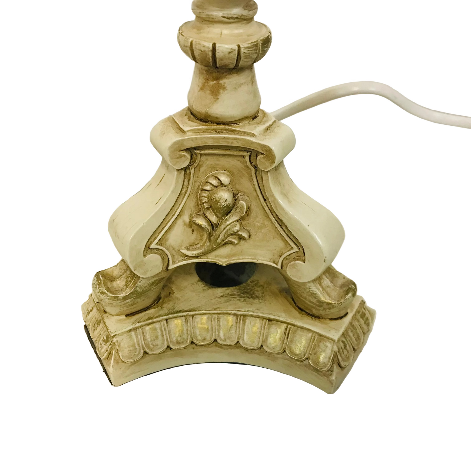 Decorative lamp base with intricate design on a white surface