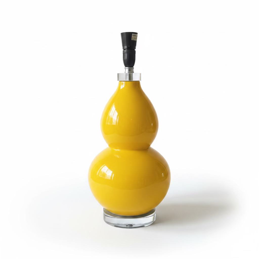 A glossy yellow gourd-shaped table lamp with black lamp fittings and clear round bases, photographed on a clean white studio background.