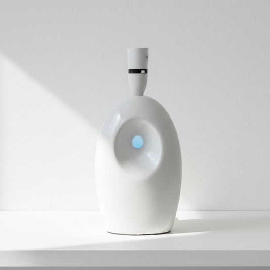 White LAMP BASE on a wooden table with a store interior in the background