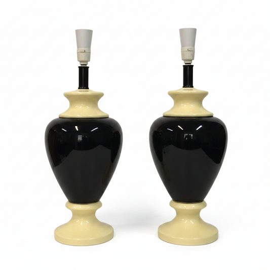 Two black and cream ceramic table lamps on a white background