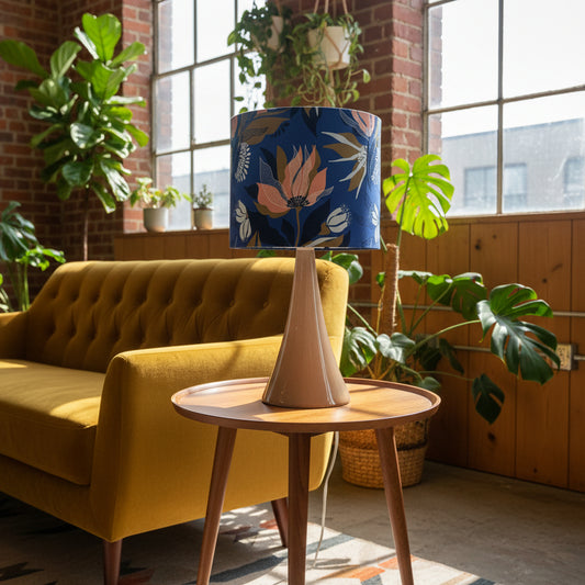 Living room with yellow sofa, wooden side table, and floral-patterned lamp.