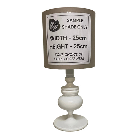 Lamp with a sample shade label on a plain background