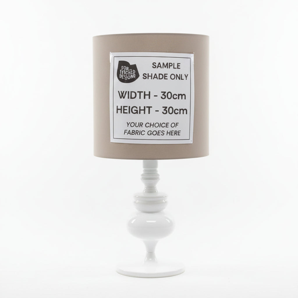 Lamp with a sample shade label on a plain background