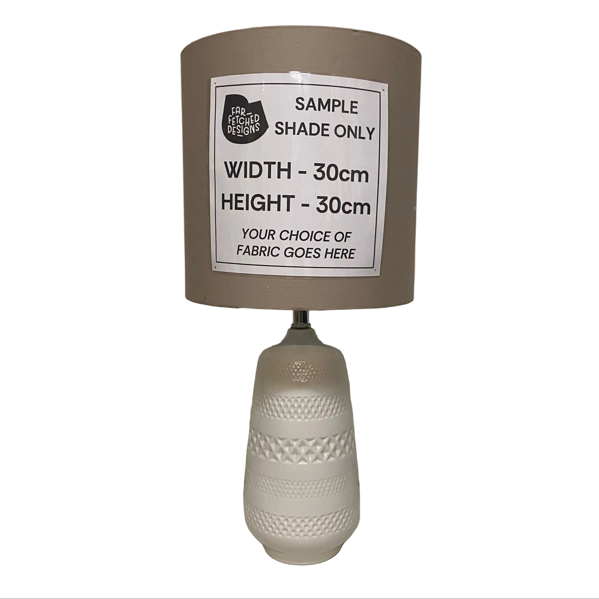 Lamp with a sample shade label on a plain background