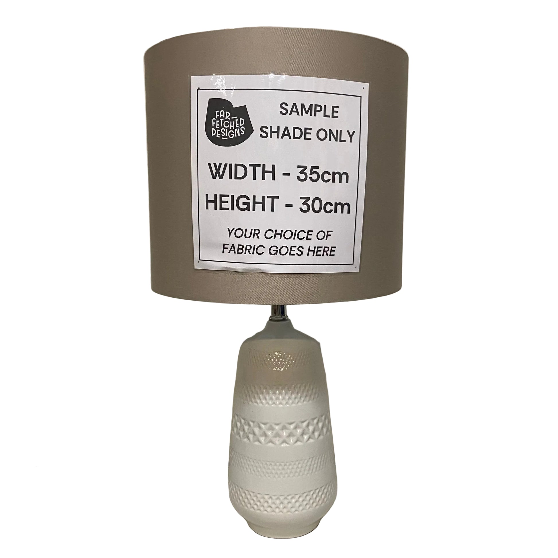 Lamp with a gray shade and white base on a plain surface.