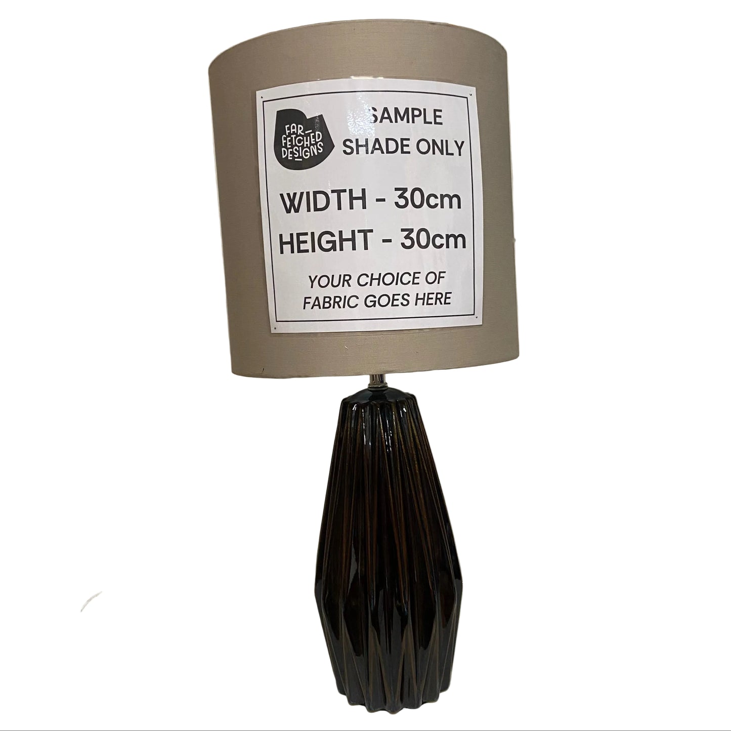 Lamp with a sample shade label on a white surface