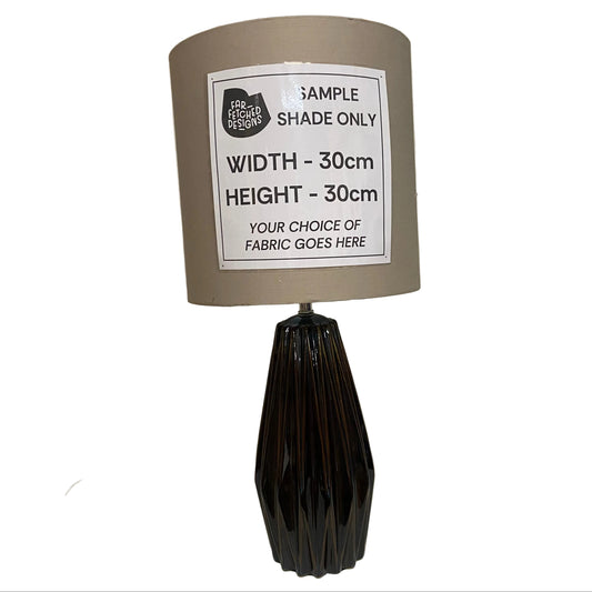 Lamp with a sample shade label on a white surface