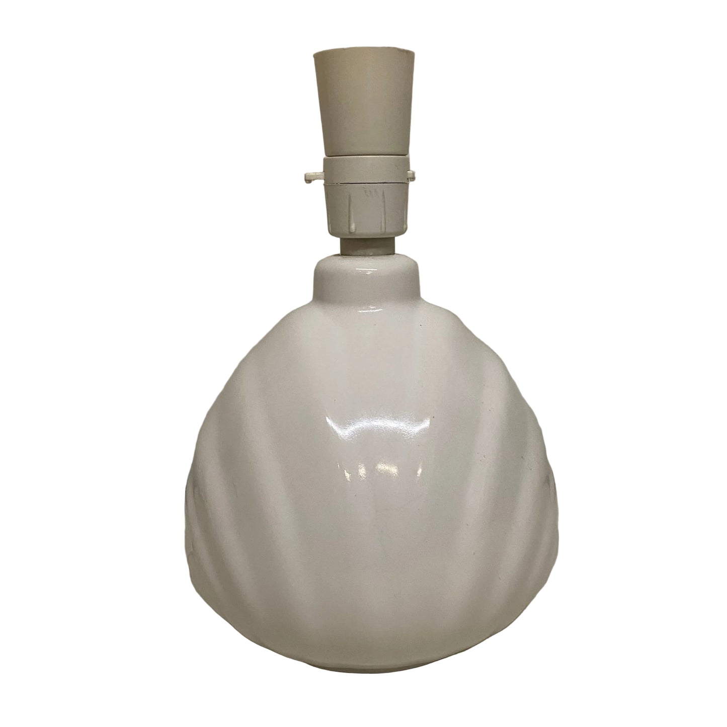 White ceramic lamp base with beige lampshade on a plain surface.