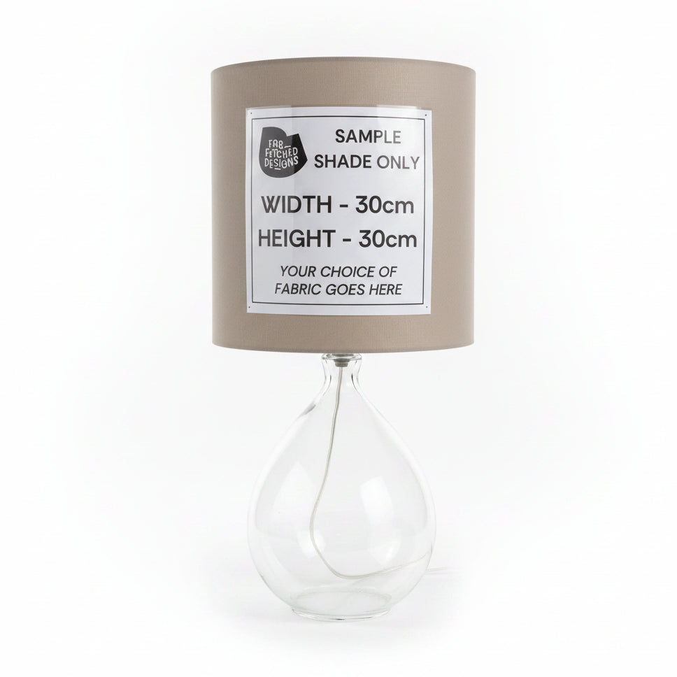 Lamp with a sample shade and text label on a white surface.