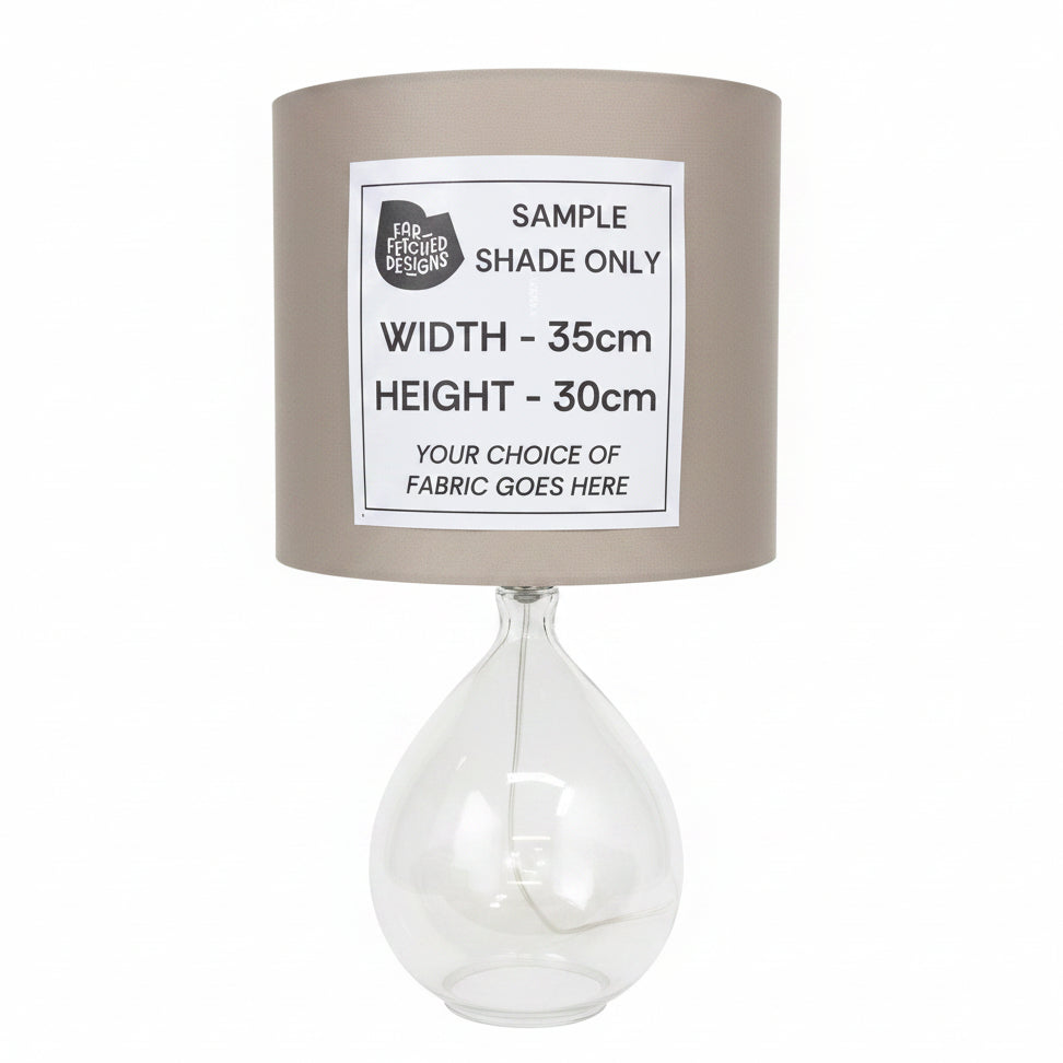 Lamp with a sample shade and dimensions label on a white surface.