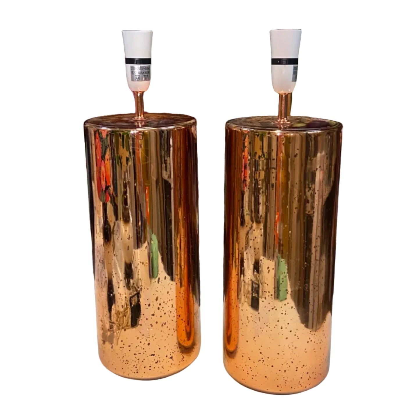 Two metallic cylindrical lamp bases on a white background