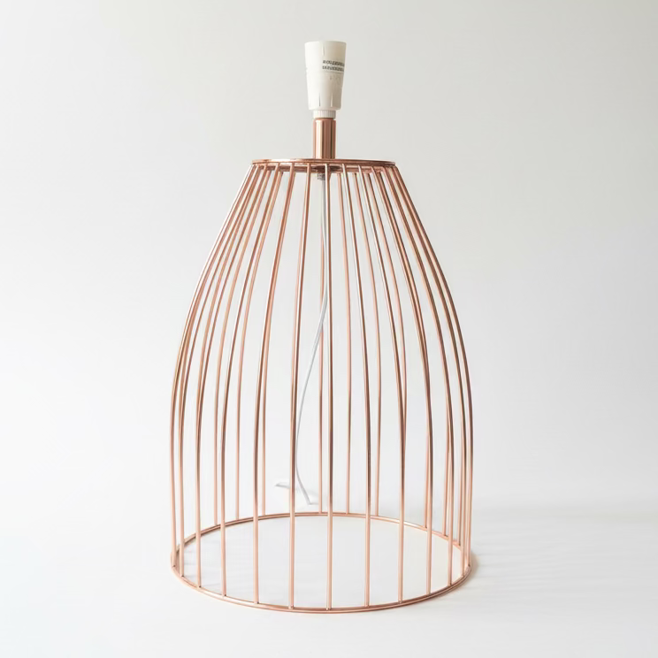 A copper wire cage table lamp with white sockets, photographed on a clean white background.