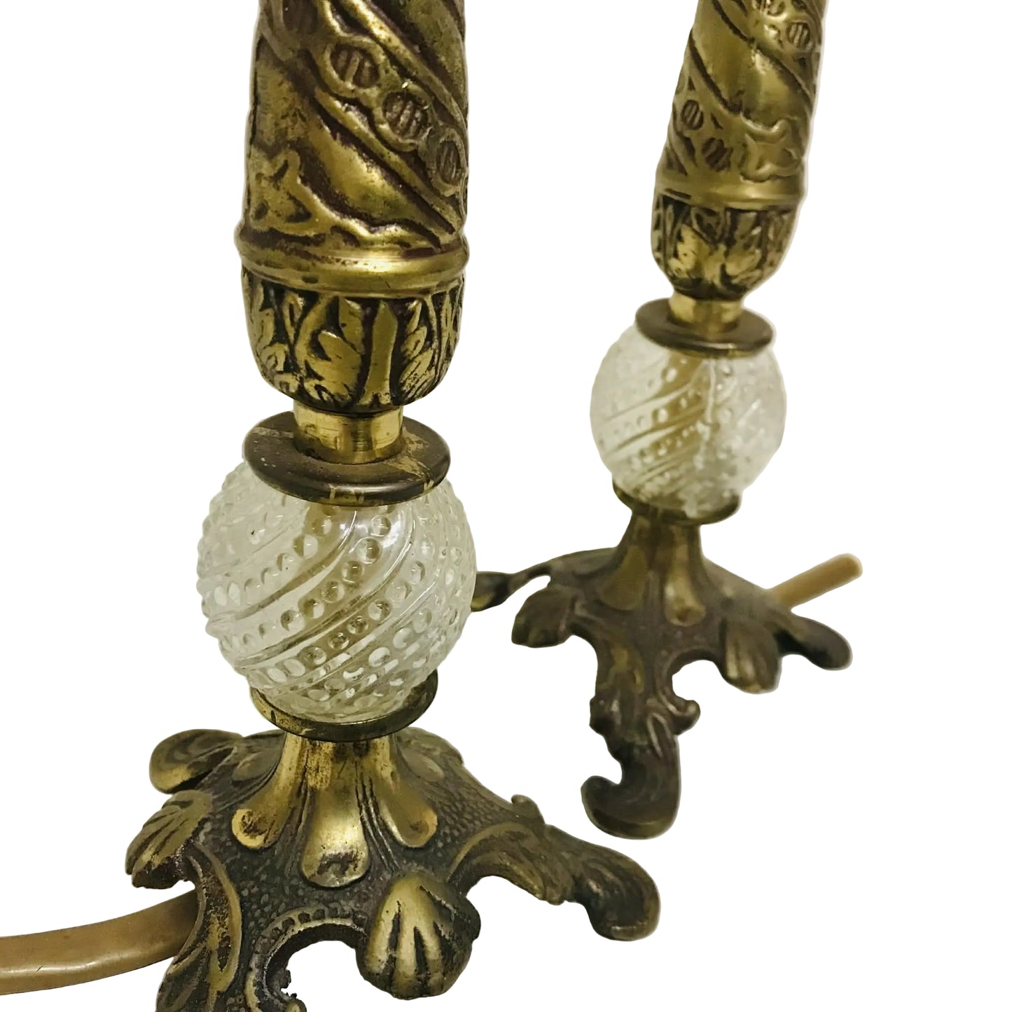 Pair of ornate brass lamps with glass shades on a white surface.