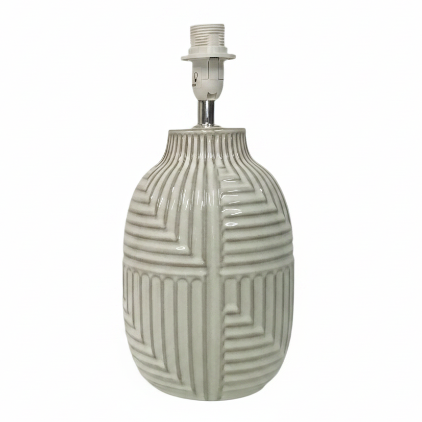 A ceramic table lamp with a glossy, ribbed geometric-patterned vase-shaped base in a light cream or off-white glaze, topped with a white threaded socket and a silver metal stem, shown against a plain white background.