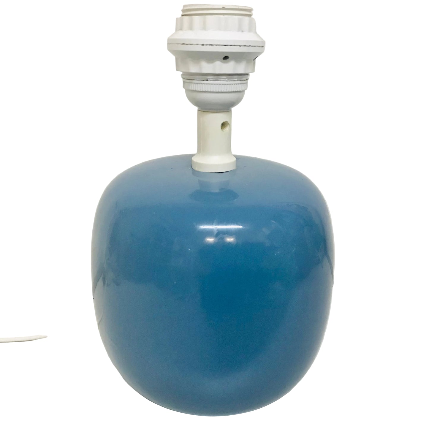 Blue ceramic lamp with white base on a white background