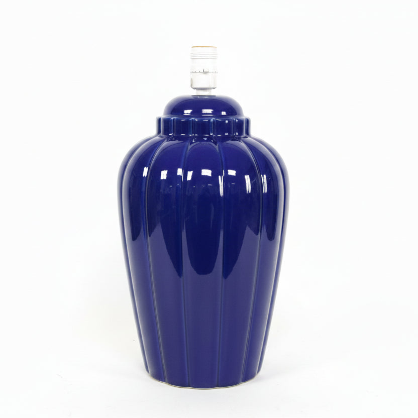 Navy blue ceramic lamp with a white  background
