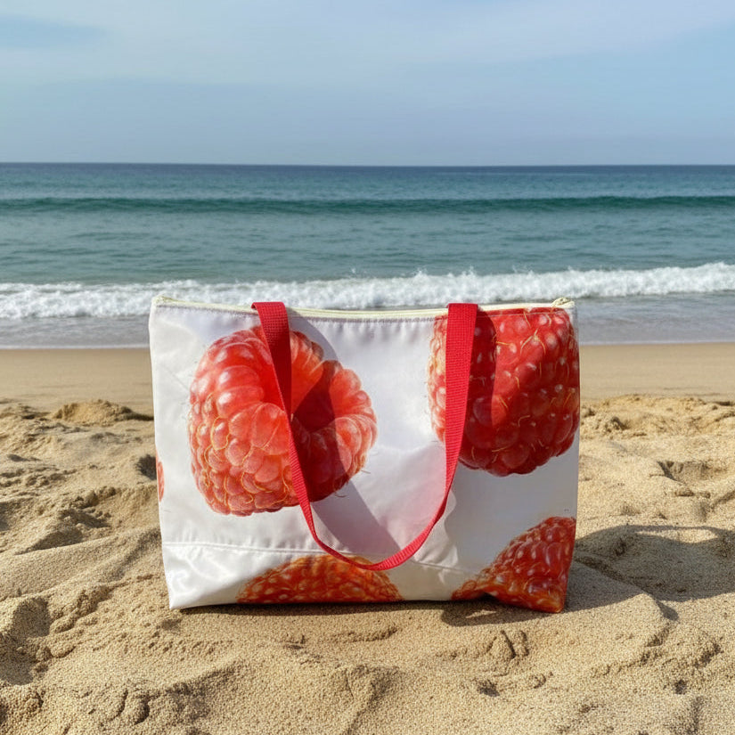 Tote bag with raspberry design on a sandy beach