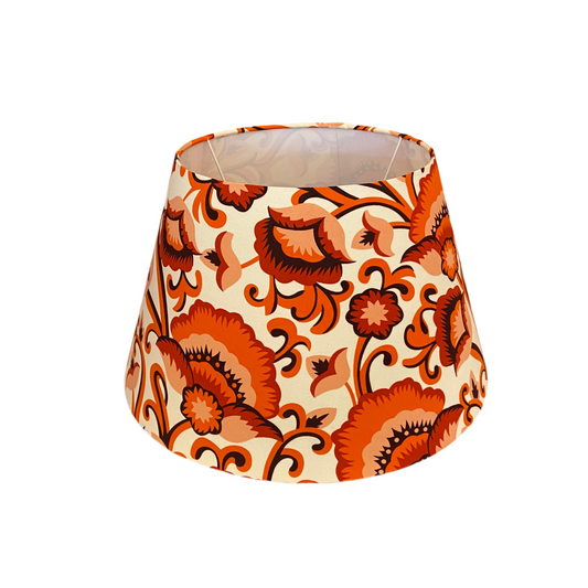 Decorative lampshade with orange floral pattern on a white background