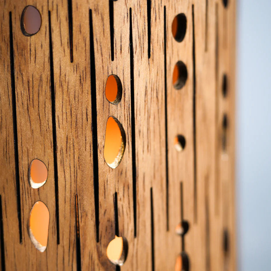 Wooden panel with circular cutouts and a gradient background