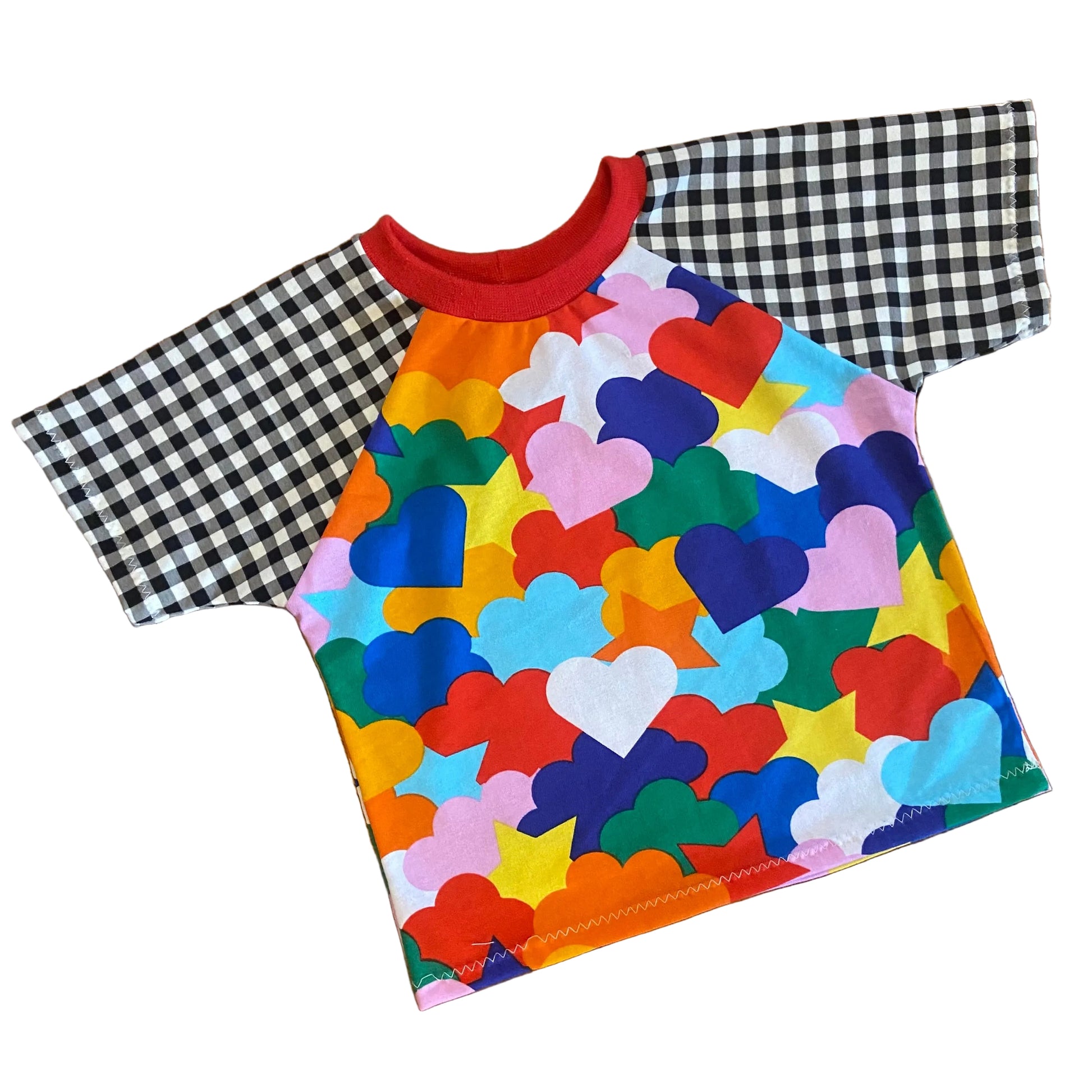 Colorful t-shirt with heart and cloud shape pattern on a white background