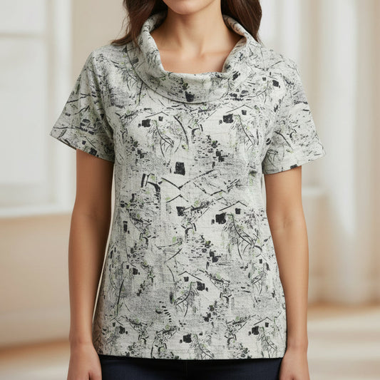 Short-sleeve shirt with abstract pattern on a mannequin against a brick wall.