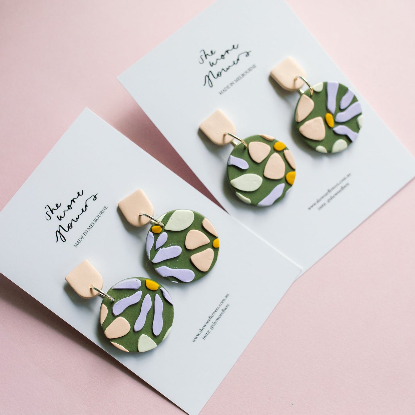 Pair of floral earrings on a matching card with 'She She Flowers' branding on a pink background