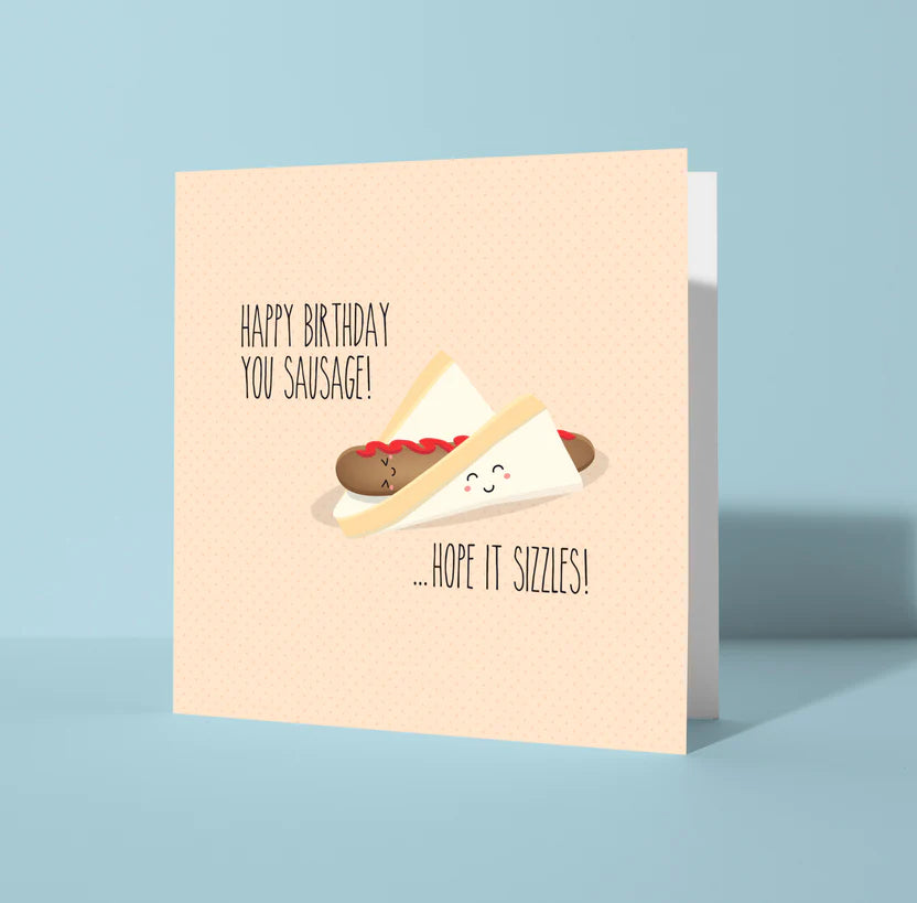 Birthday card with a sausage graphic and humorous text on a light blue background