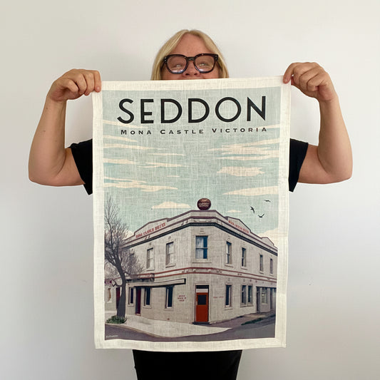 Person holding a print of Seddon, Mona Castle, Victoria with a building illustration.