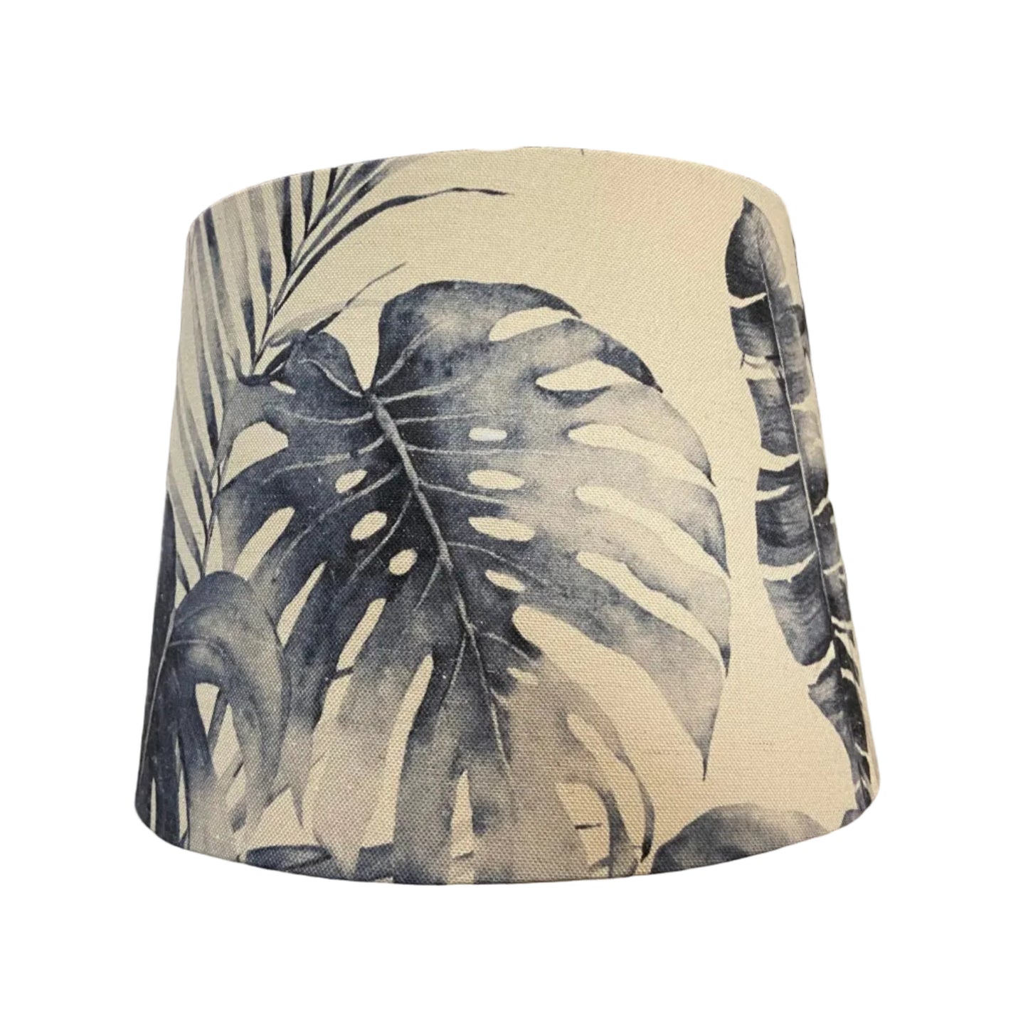 Tropical leaf patterned lampshade on a white background