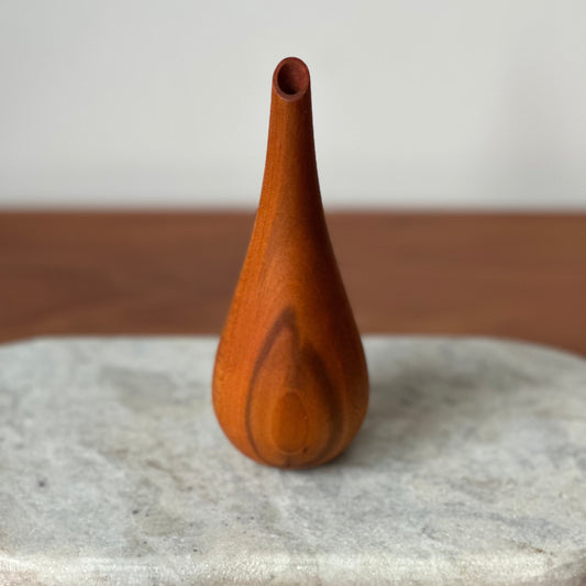 Wooden vase on a stone surface with a neutral background