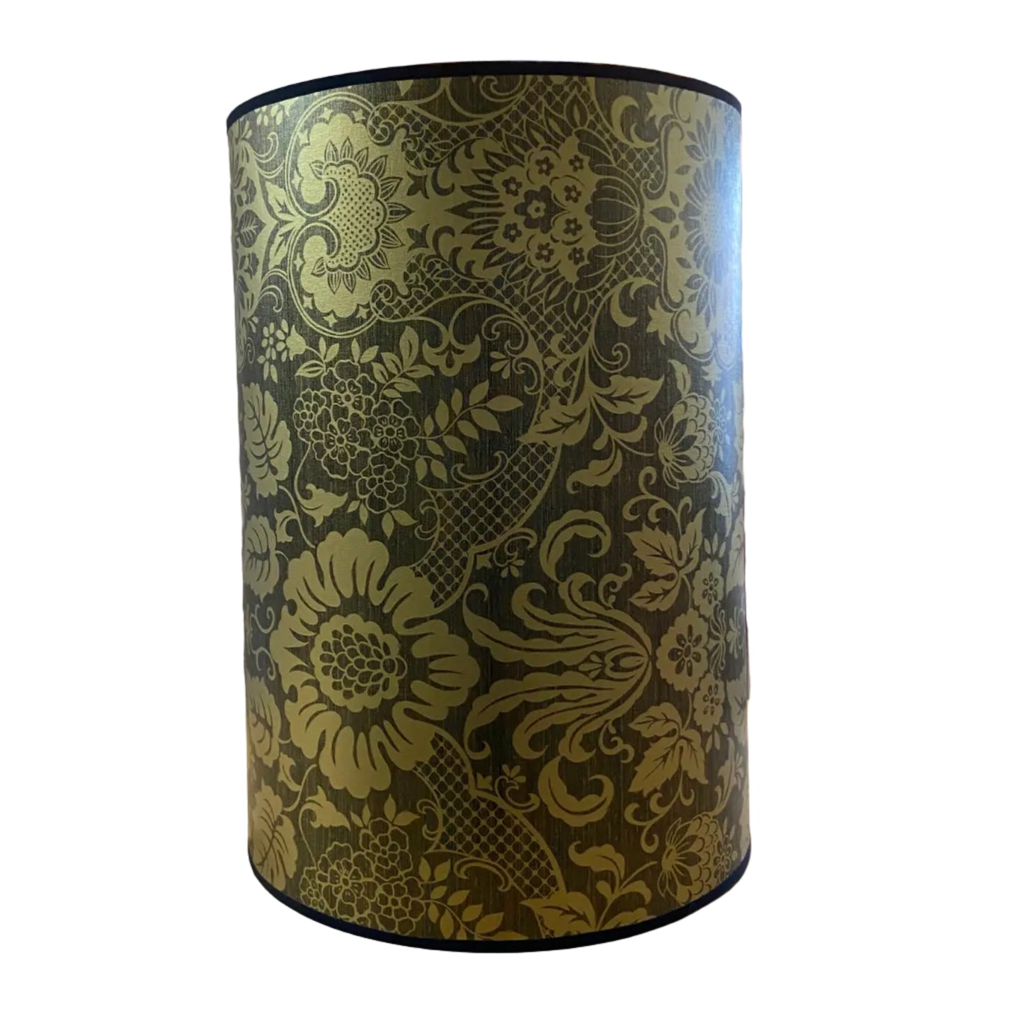 A cylindrical lampshade with a black and matt gold floral damask pattern, displayed on a white background