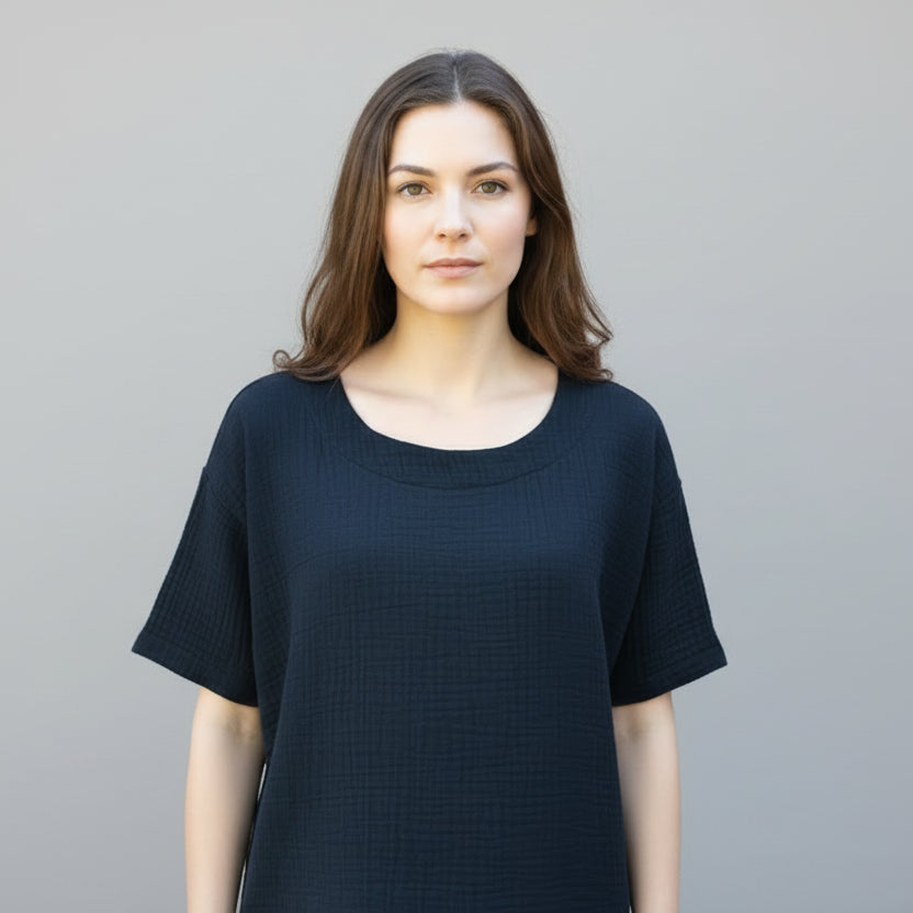black textured top on a mannequin against a brick wall background