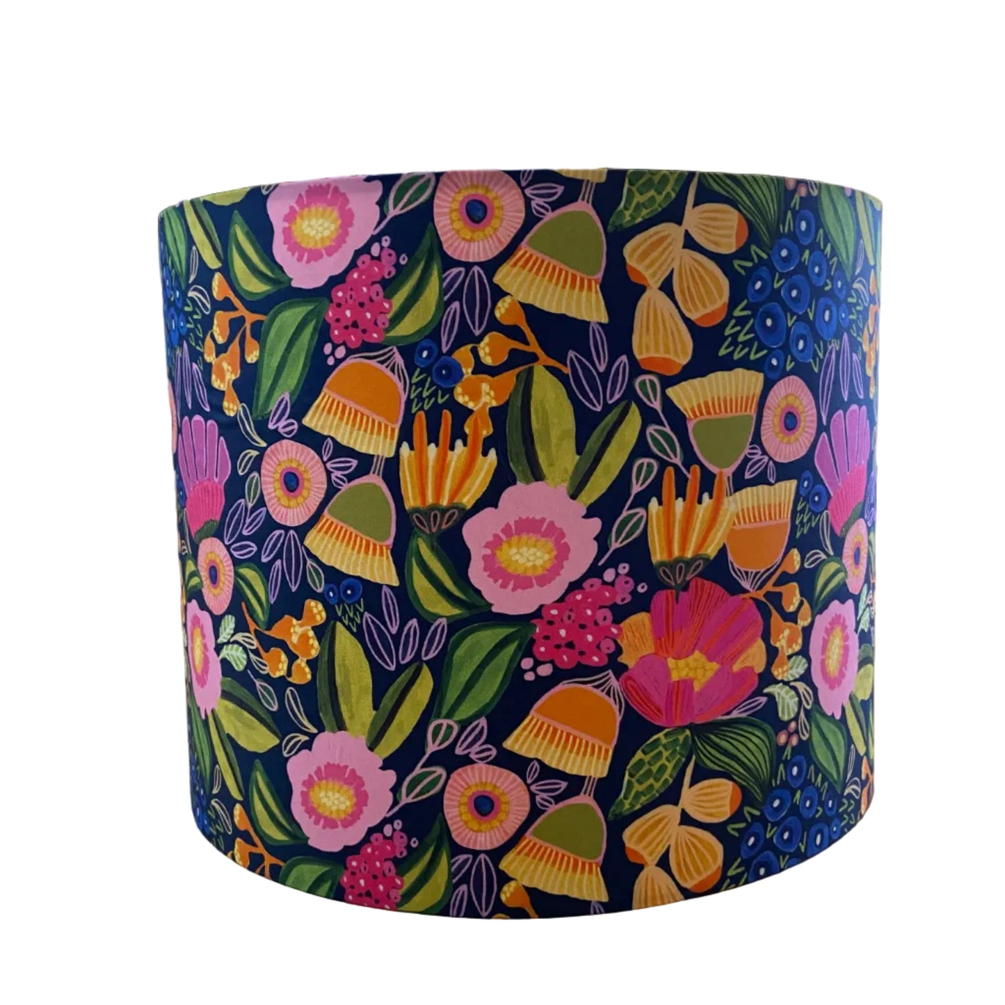 A cylindrical lampshade with a vibrant, multicolored floral and botanical pattern on a dark navy background, displayed on a white background