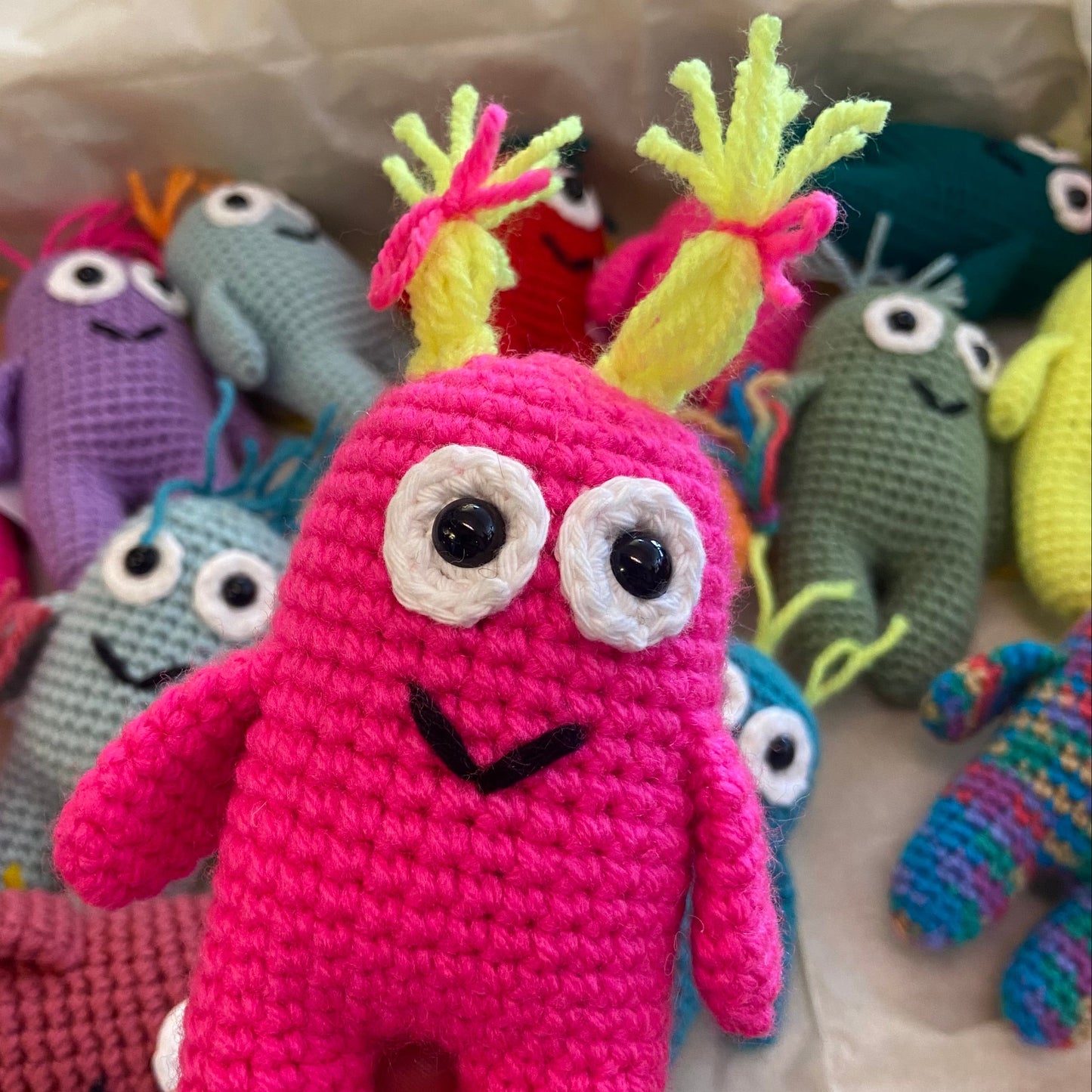 Colorful crochet monsters on a white background