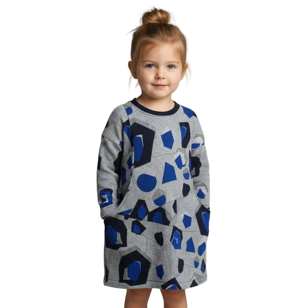 Child wearing a gray sweater dress with blue geometric patterns on a plain background
