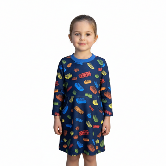 Child wearing a colorful patterned dress on a white background