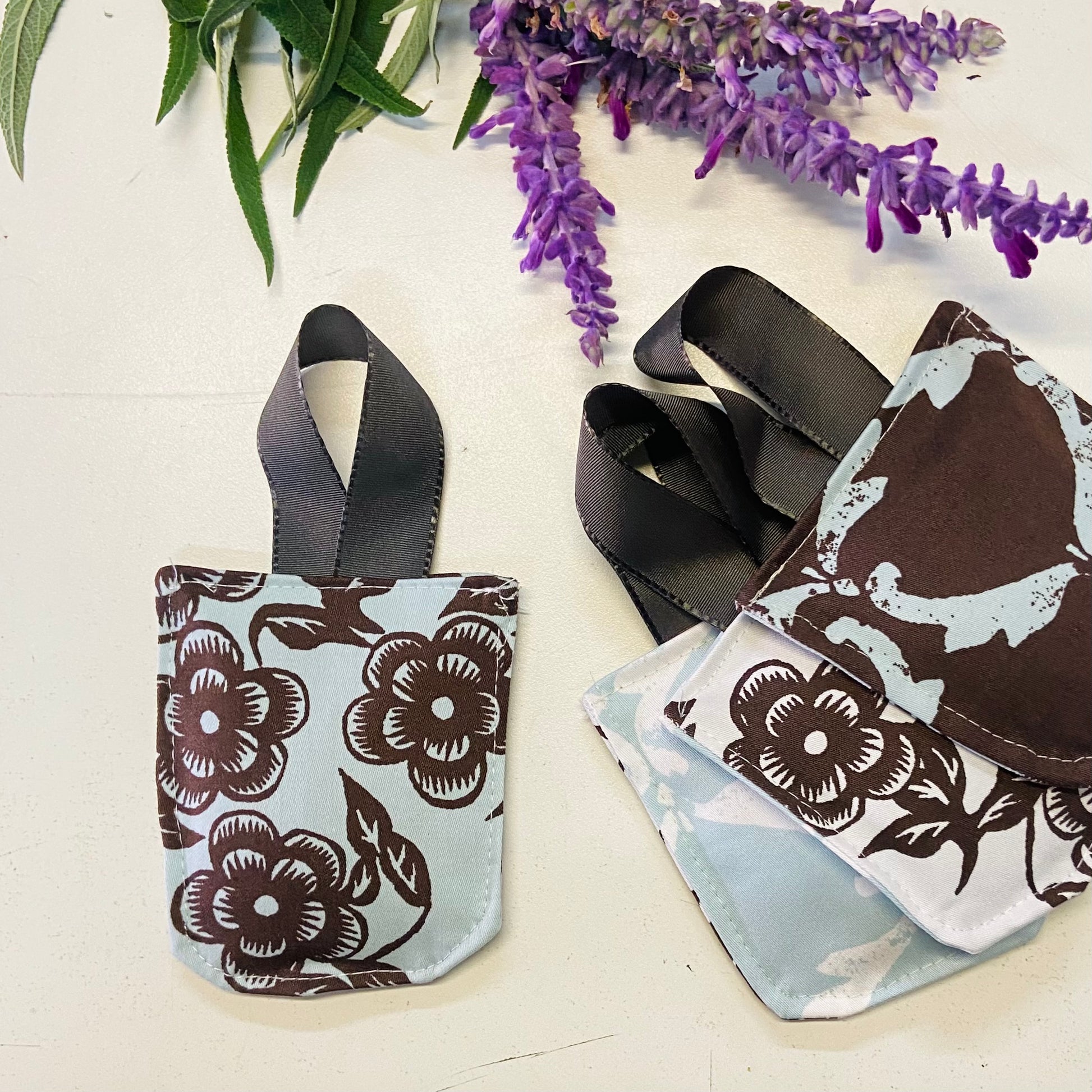 small hanging pouch filled with lavender to hang in your wardrobe or place in your clothing drawers to leave the space gmelling fresh. This set of four pouches have a blue , white & choclate floral textile.