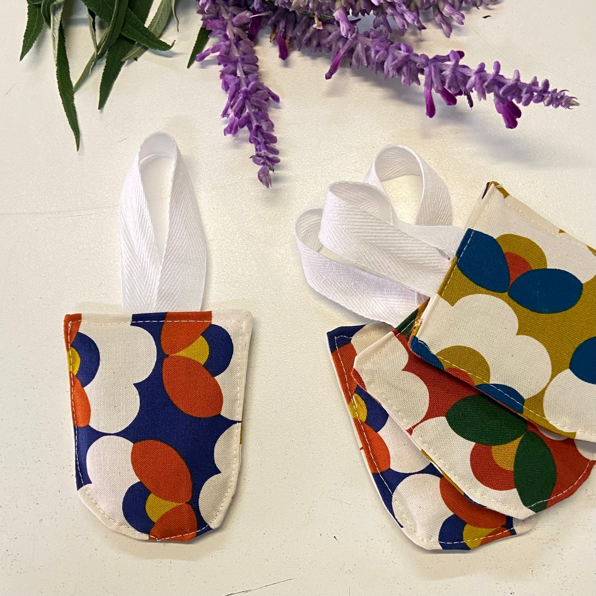 small hanging pouch filled with lavender to hang in your wardrobe or place in your clothing drawers to leave the space gmelling fresh. This set of four pouches have a retro floral textile.