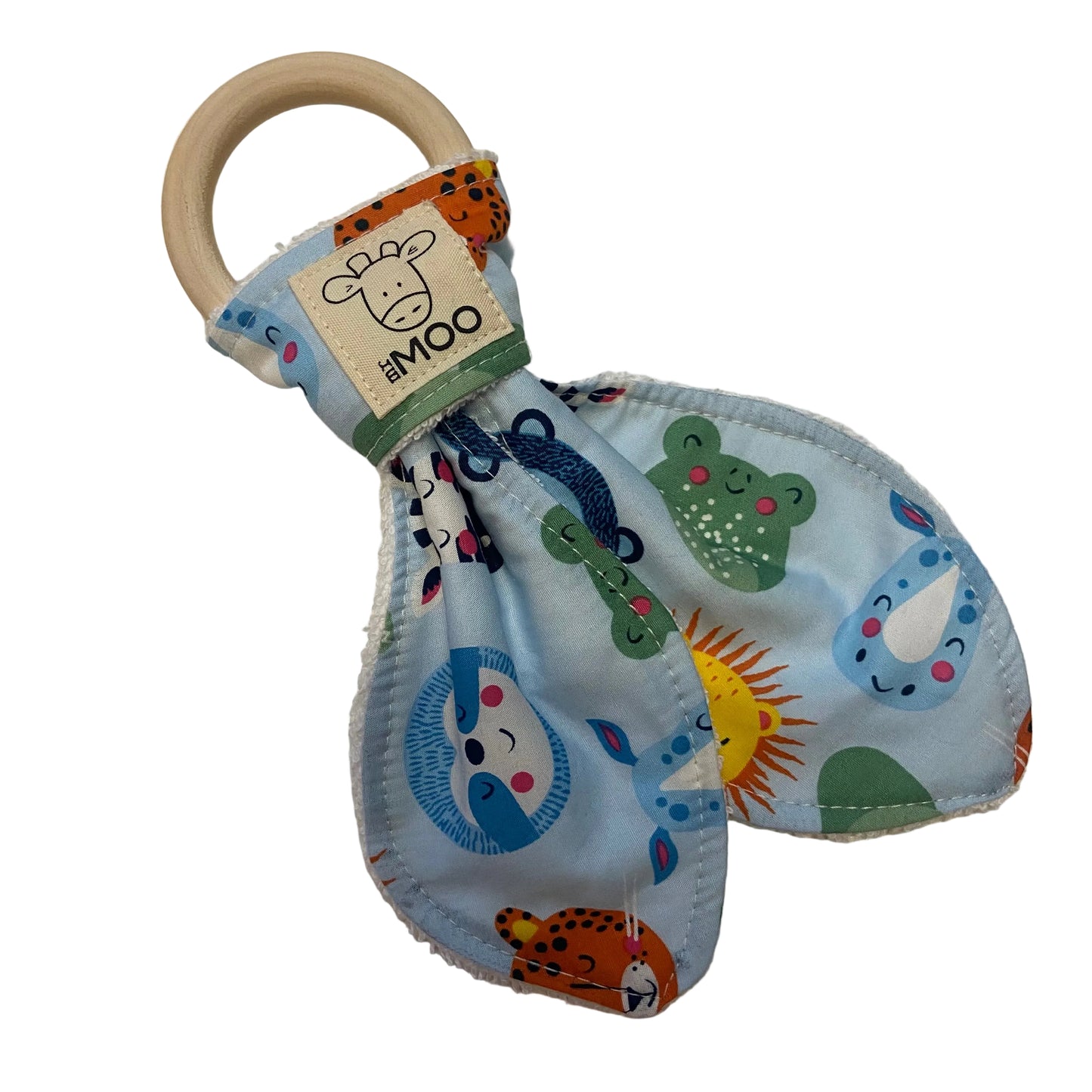 Teething ring with colorful fabric cover and wooden ring on a white surface